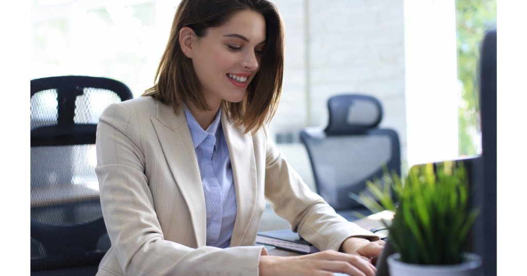 Building Client Relationships shows lady solopreneur sitting at laptop computer working.